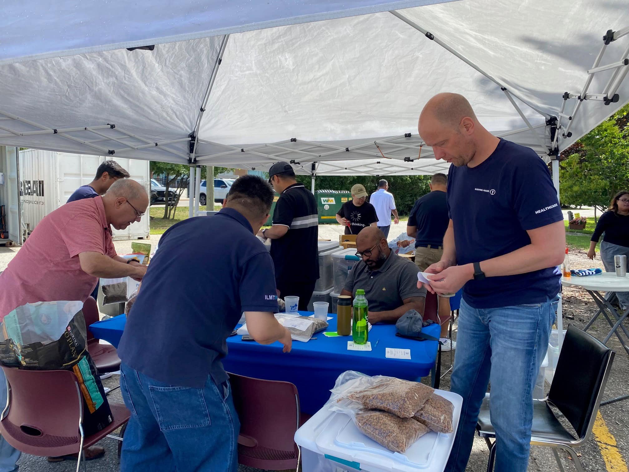 corporate volunteers packing pet supplies kuehne