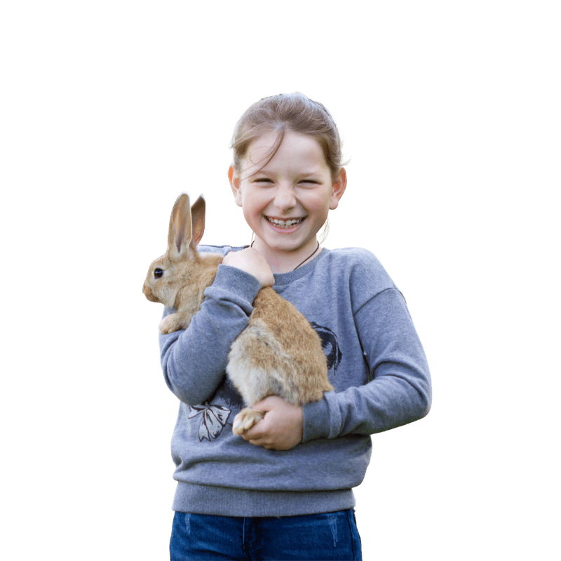 girl holding rabbit outdoor